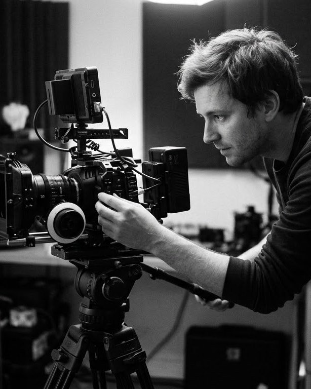 A filmmaker framing a shot on a cinema camera